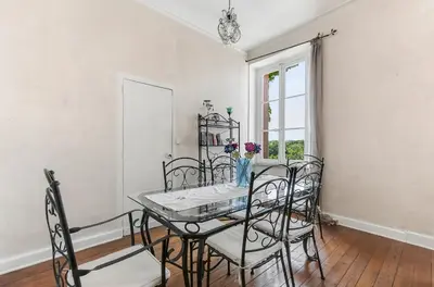 a dining room with a glass table and chairs at Les Bellevue Cité 