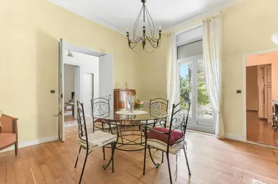 a dining room with a table and chairs and a chandelier at Les Bellevue Cité 