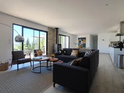 a living room with a couch and a table at Stylish villa in Beaufort with private pool in Beaufort