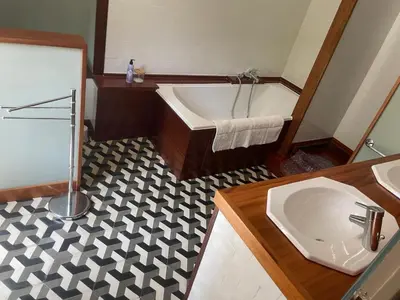 a bathroom with a tub and a toilet and a sink at Residence le Petit Paradis in Labastide-Rouairoux