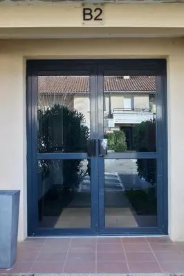 a sliding glass door of a building at Appart Chrystal in Carcassonne