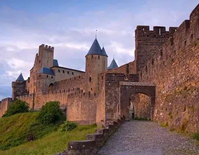 a large castle with an archway in front of it at Appart Chrystal in Carcassonne