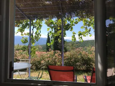 a view from a window of a table and chairs at Maisonnette El Puy in Molitg les Bains