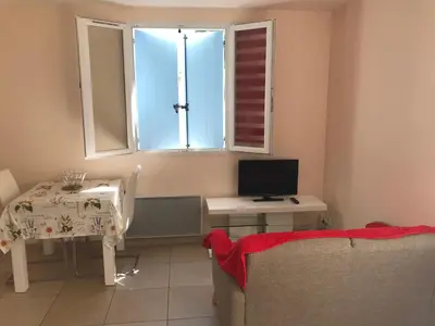 a living room with a table and a television at Maisonnette El Puy in Molitg les Bains