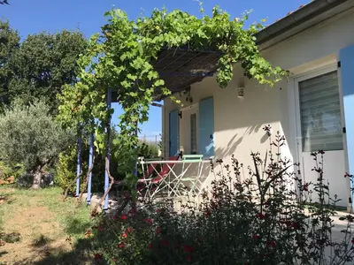 a house with a pergola on the front porch at Maisonnette El Puy in Molitg les Bains