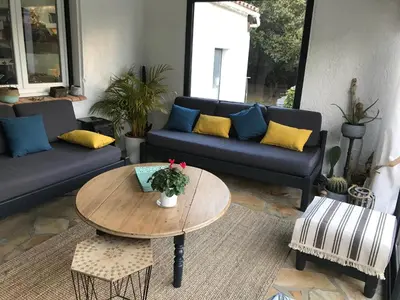 a living room with a couch and a table at Chambre d'hôte à La maison du petit bois 4 étoiles in Ventenac-Cabardès