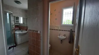 a bathroom with a sink and a toilet and a window at Lenga doc in Prades-sur-Vernazobre