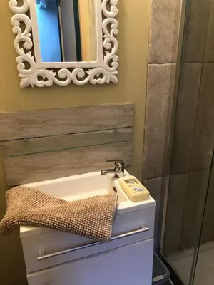 a bathroom with a sink and a mirror at Le Petit Relais du Canal in Trèbes