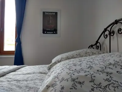 a bedroom with a bed and a picture on the wall at Number15 Guesthouse Carcassonne in Carcassonne