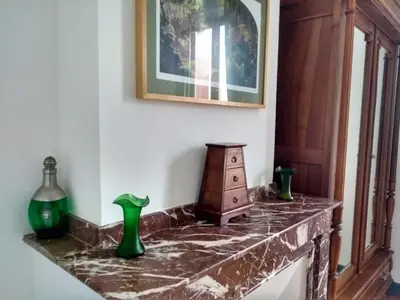 a marble counter with vases and a picture on a wall at Number15 Guesthouse Carcassonne in Carcassonne
