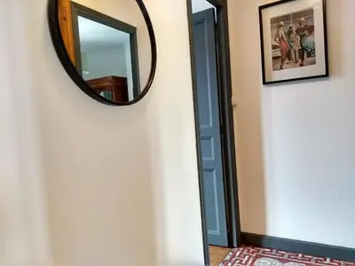 a mirror on a wall next to a door at Number15 Guesthouse Carcassonne in Carcassonne
