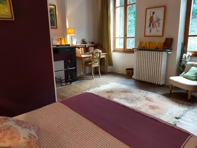 a bedroom with a bed and a desk and a chair at Burlats in Burlats