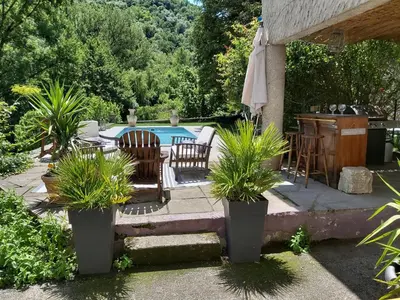 a patio with a table and chairs and a pool at Burlats in Burlats