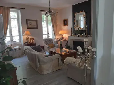 a living room with two couches and a mirror at Burlats in Burlats