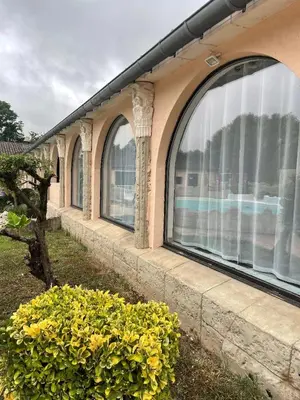 a row of windows on the side of a building at gîtes Studio de tourisme du Domaine Piscine Spa Balnéo in Lescout