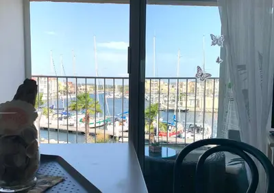 a room with a view of a marina from a window at Cap Gruissan Vacances (11) in Gruissan