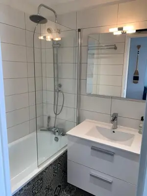 a white bathroom with a sink and a shower at Cap Gruissan Vacances (11) in Gruissan