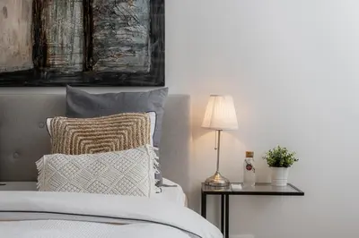 a bedroom with a bed with a lamp and a pillow at Ecole Olargues - Chambres & restaurant - Teritoria in Olargues