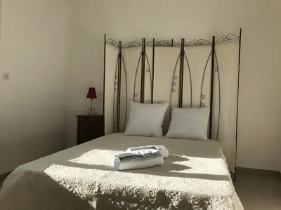 a bed with two towels on top of it at VILLA PINTOURINA in Sallèles-dʼAude