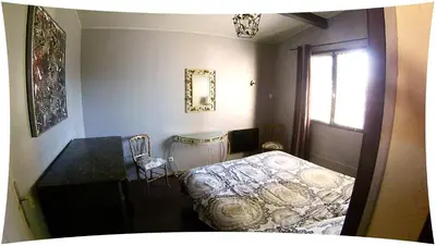 a bedroom with a bed and a desk and a window at Le Moulin du Christ in Peyrefitte-sur-lʼHers