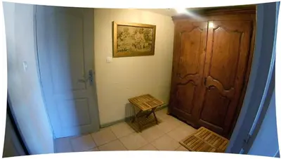 a small hallway with a door and a stair case at Le Moulin du Christ in Peyrefitte-sur-lʼHers