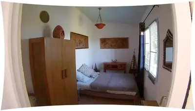 a small bedroom with a bed and a dresser at Le Moulin du Christ in Peyrefitte-sur-lʼHers