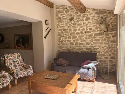a living room with a couch and a table at Chez Elia, pour les amoureux des vieilles pierres in Cesseras