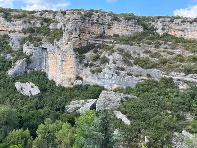 a view of a mountain with trees and rocks at Chez Elia, pour les amoureux des vieilles pierres in Cesseras