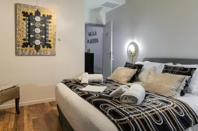 a bedroom with a large bed with towels on it at Hotel Galla Placidia in Narbonne