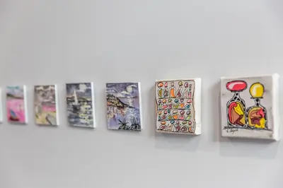 a row of pictures hanging on a wall at Hotel Galla Placidia in Narbonne