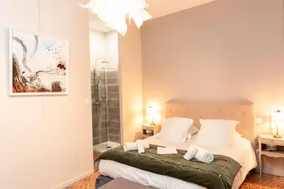 a bedroom with a bed with two towels on it at Hotel Galla Placidia in Narbonne