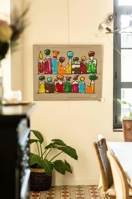 a painting of bottles on a wall with a plant at Hotel Galla Placidia in Narbonne