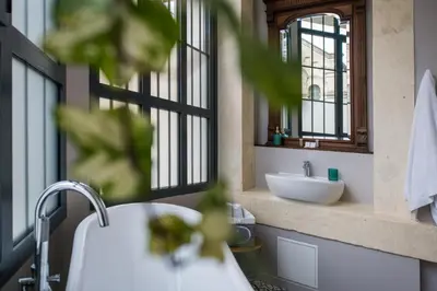 a bathroom with a sink and a mirror at Hotel Galla Placidia in Narbonne
