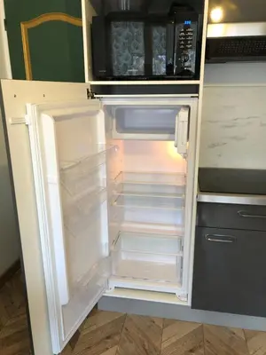 an empty refrigerator with its door open in a kitchen at Les Palmiers de Gruissan, T2, Vue Port ! in Gruissan