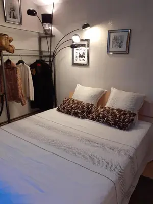 a bedroom with a bed with white sheets and pillows at La Bergerie in Lagarrigue