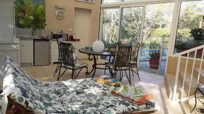 a living room with a couch and a table and chairs at La Bergerie in Lagarrigue
