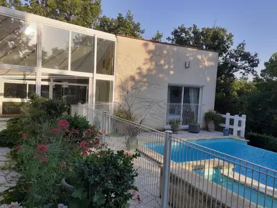 a house with a swimming pool in front of it at La Bergerie in Lagarrigue