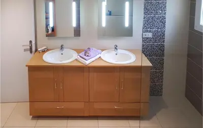 a bathroom with two sinks and a shower at 3 Bedroom Nice Home In Quarante in Quarante