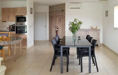 a kitchen and dining room with a table and chairs at 3 Bedroom Nice Home In Quarante in Quarante