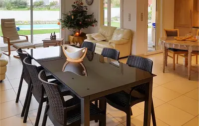 a dining room with a table and chairs at 3 Bedroom Nice Home In Quarante in Quarante