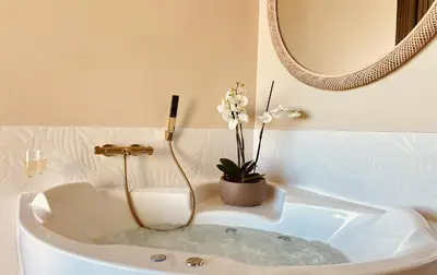 a bath tub with clouds in it in a room at La Lagune in Bages
