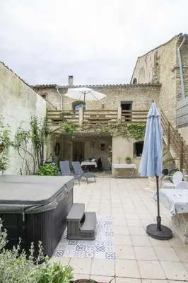a garden with a couch and chairs in the grass at La Bastide des Roses in La Bastide-sur-lʼHers