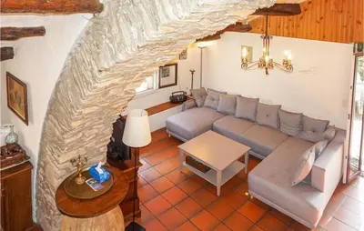 a living room with a couch and a table at 2 Bedroom Amazing Home In Olargues in Olargues