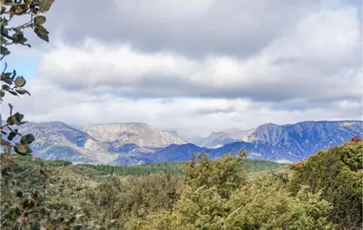 a view of mountains and trees in the distance at 2 Bedroom Amazing Home In Olargues in Olargues