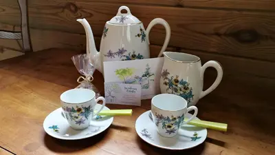 two tea cups and a tea set on a table at Les Cabanes d'Hestia in La Salvetat