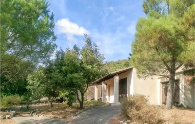 a house with trees in front of it at Awesome Home In Pierrerue in Pierrerue