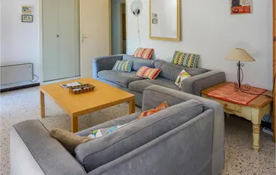 a living room with two couches and a table at Awesome Home In Pierrerue in Pierrerue