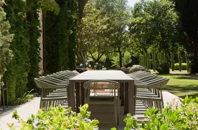 a group of chairs around a table in a garden at Domaine de la JASSO, Demeure de grand luxe au pied de la Cité de Carcassonne, piscines et parc animalier in Carcassonne