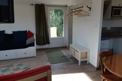 a room with a bed and a table and a window at Studio dans un cadre champêtre in Mas-Saintes-Puelles