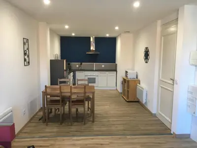 a kitchen with a table and a dining room at La Cathare Appartement 2 chambres in Lézignan-Corbières